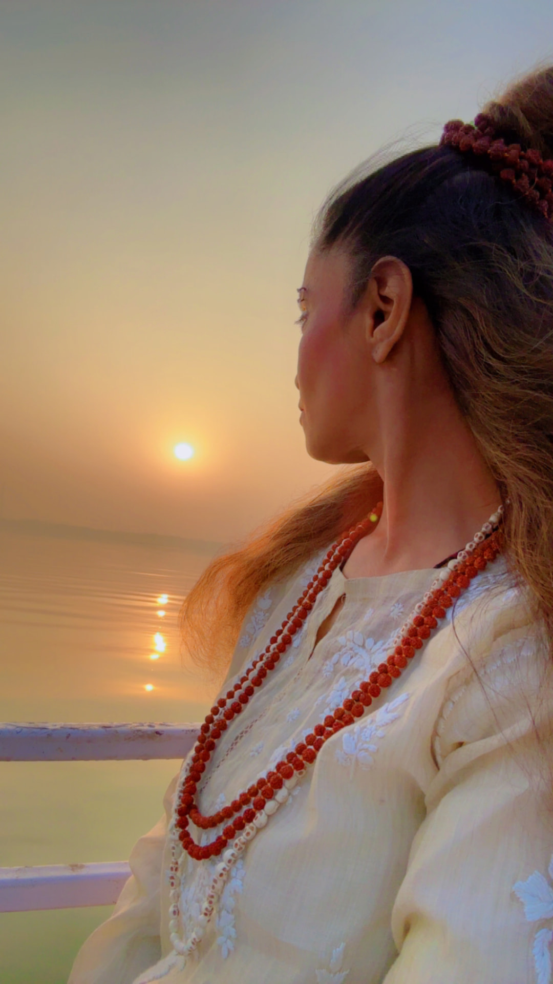 Suhaila watching the sunrise over the river
